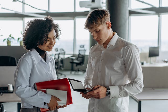 Two people in an office talking